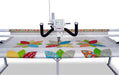 Janome Quilt Maker 18 long arm quilting machine actively quilting a patterned fabric, highlighting stitch accuracy and large work area