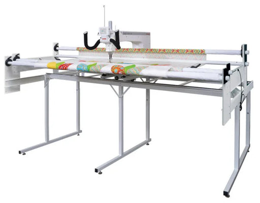 Janome Quilt Maker 18 long arm quilting machine with 8 foot ProFrame shown at an angle, complete quilting setup for home studio and large quilt projects