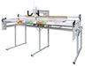 Janome Quilt Maker 18 long arm quilting machine with 8 foot ProFrame shown at an angle, complete quilting setup for home studio and large quilt projects