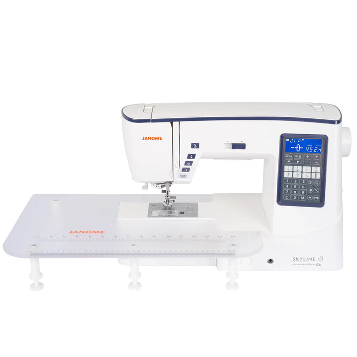 Janome Skyline S6 Anniversary Edition sewing machine with large extension table attached for quilting and oversized projects.