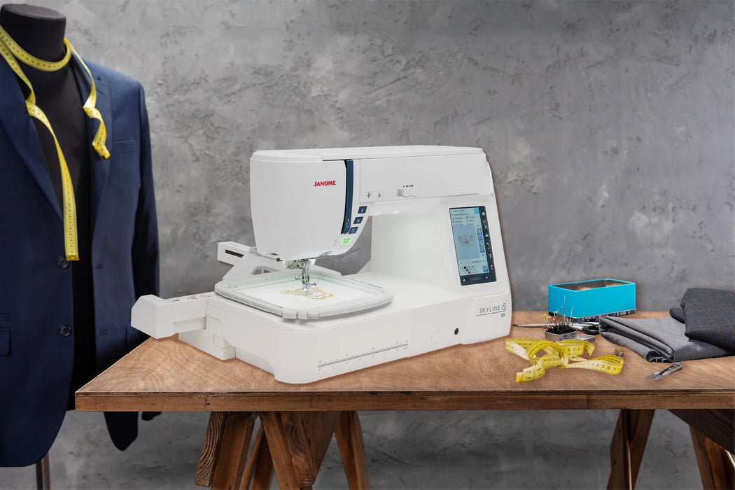Janome Skyline S9 sewing and embroidery machine set up in a professional studio environment with embroidery hoop attached.