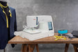 Janome Skyline S9 sewing and embroidery machine set up in a professional studio environment with embroidery hoop attached.