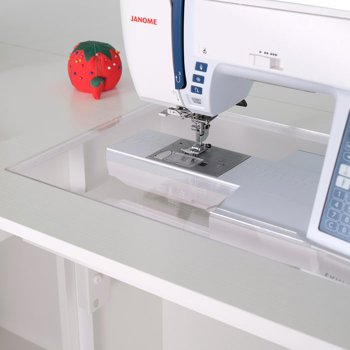 Close-up of sewing machine inside white Kangaroo & Joey cabinet with acrylic insert for flatbed sewing