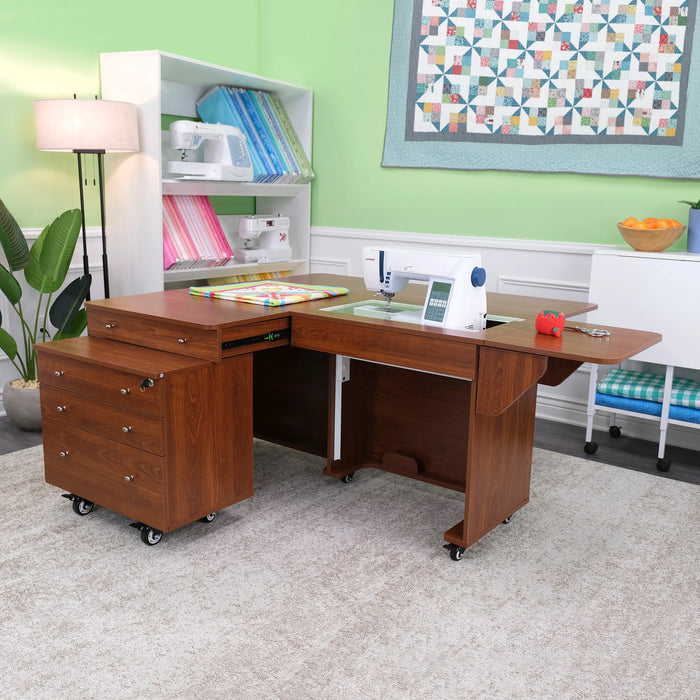 Kangaroo & Joey Sewing Cabinet set up in a craft room, featuring expansive quilting workspace, teak wood design, and rolling Joey storage unit.