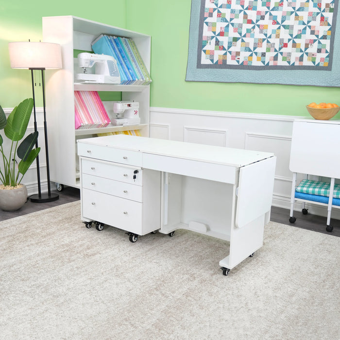 Compact folded Kangaroo & Joey Sewing Cabinet in white with Joey storage caddy tucked underneath, displayed in modern quilting and sewing workspace.