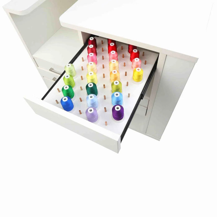 Kangaroo Ava 93018J cabinet pull-out thread drawer with built-in pegs holding colorful embroidery thread cones for organized sewing studio storage.