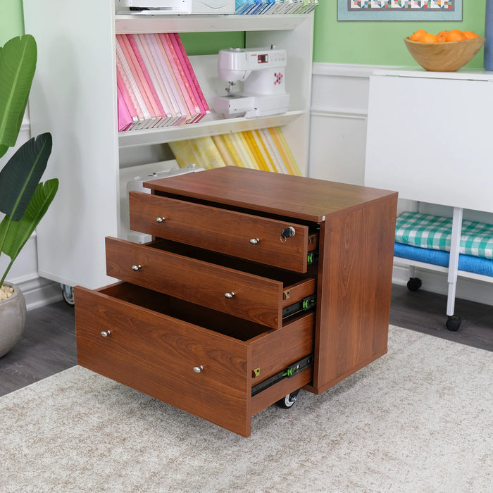 Kangaroo Joey Storage Cabinet in Teak K7805 displayed with open drawers in a sewing studio, featuring smooth-glide soft-close storage on casters.