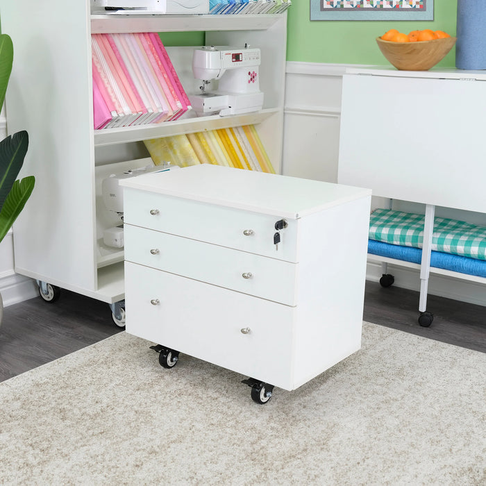 Ash White Kangaroo Joey Storage Cabinet K7811 displayed in a sewing studio, offering mobile storage for craft and quilting supplies.