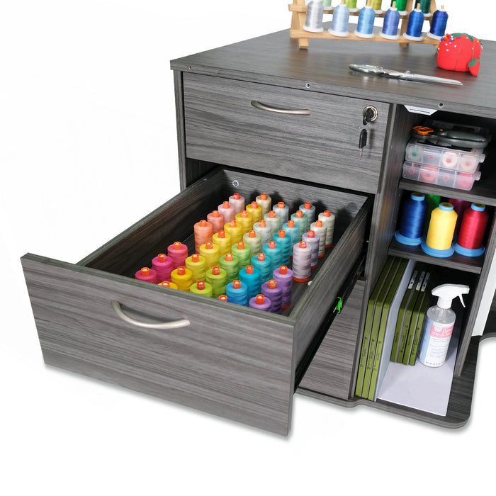Gray Sydney Lite sewing cabinet open drawer filled with organized colorful embroidery thread spools and additional craft storage shelves.