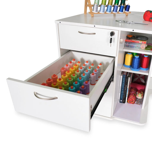 White Sydney Lite sewing cabinet open drawer filled with organized colorful embroidery thread spools and additional craft storage shelves.
