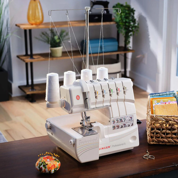 SINGER Professional 5 serger sewing machine set up on sewing table with thread stand, ideal for garment construction and professional seam finishing