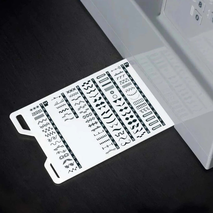Close-up of SINGER Heavy Duty 6600C stitch guide card showing built-in stitch patterns and applications