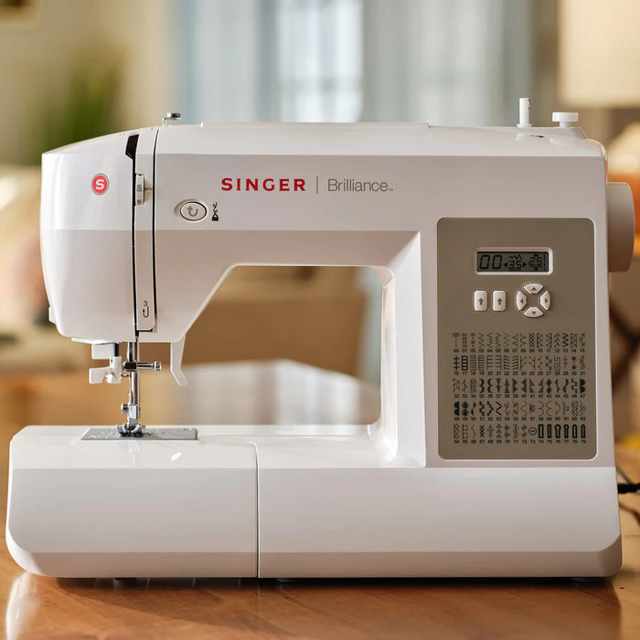 SINGER Brilliance 6180 sewing machine on tabletop showing digital display and modern home sewing setup