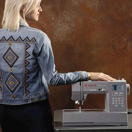 SINGER Heavy Duty 6800C sewing machine shown with custom embroidered denim jacket for creative sewing projects