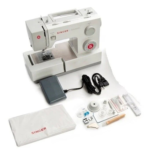 Singer 5511 Scholastic Heavy Duty sewing machine with foot pedal, power cord, accessories, bobbins, needles, and dust cover