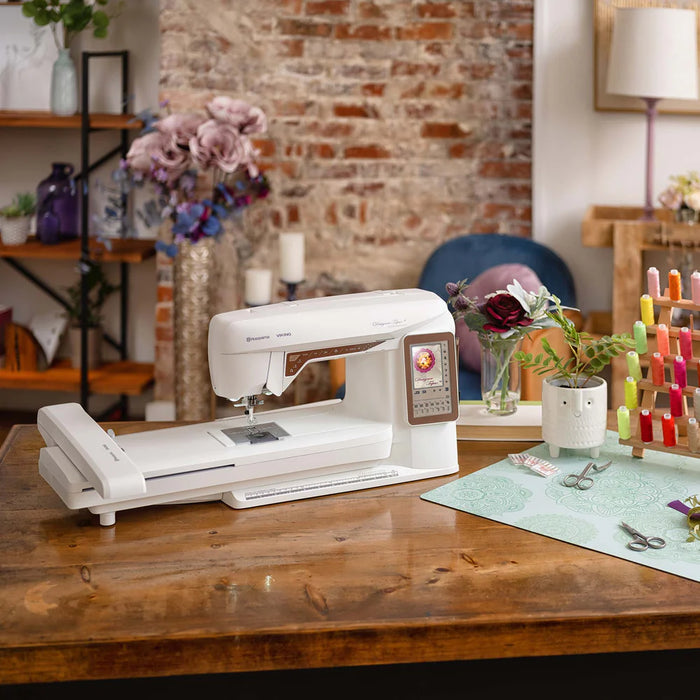Husqvarna Viking Designer Topaz 40 sewing and embroidery machine displayed on wooden table in creative sewing workspace