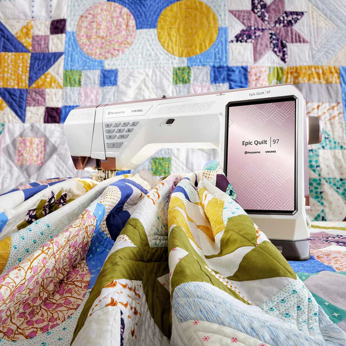 Husqvarna Viking EPIC QUILT 97 quilting a colorful patchwork quilt with large throat space for bulky projects