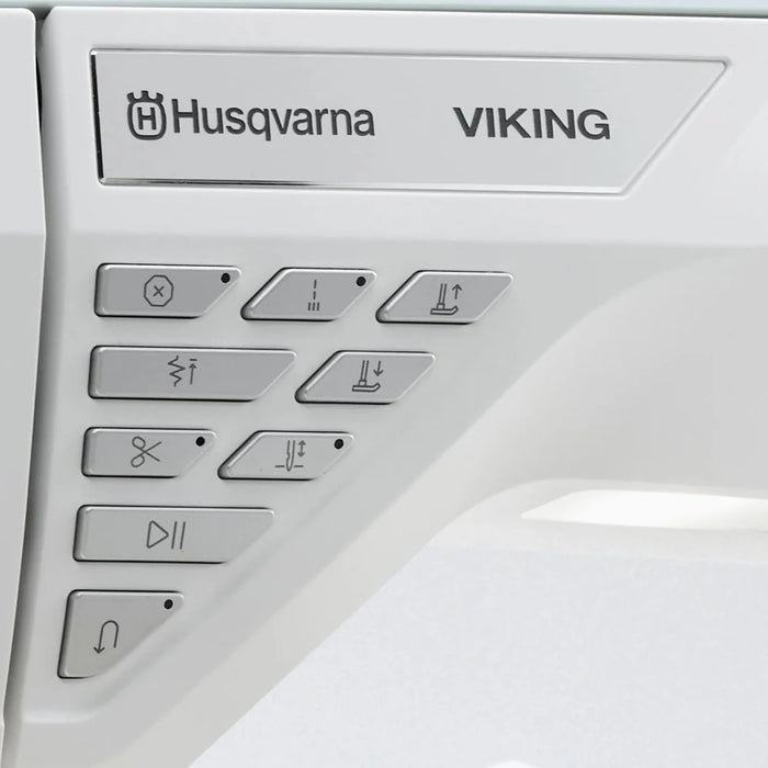 Husqvarna Viking Designer Topaz 65 sewing machine control buttons and brand logo close-up