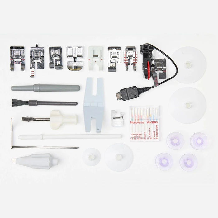 Husqvarna Viking Topaz 55Q sewing machine accessories including presser feet, bobbins, needles, tools, and power cable